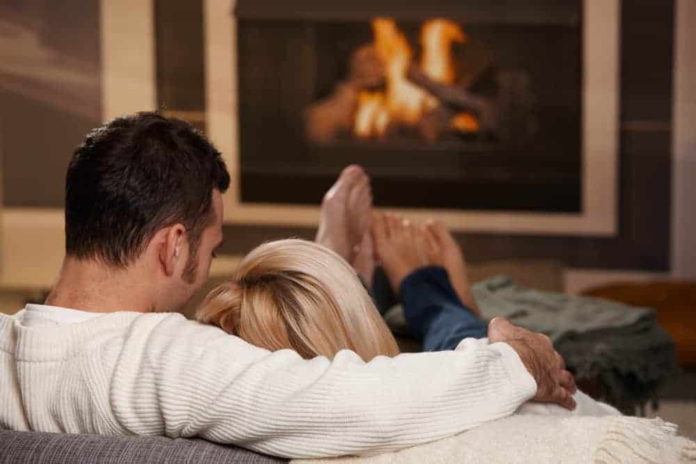 Couple sitting in front of the fireplace