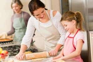 Mom and young girl baking together