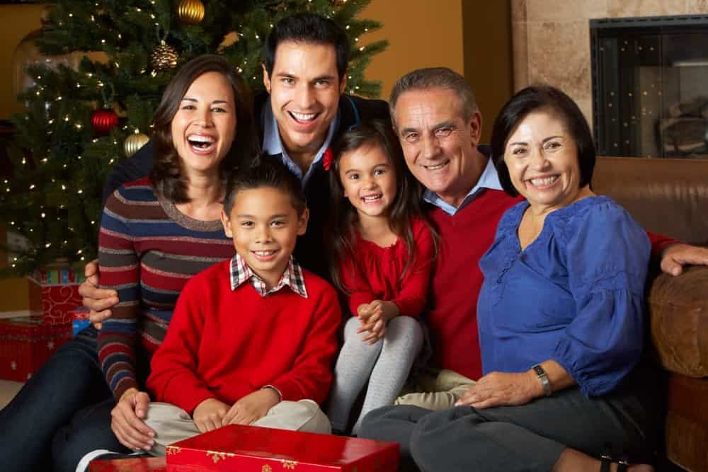 Multi-generational family in front of a Christmas tree