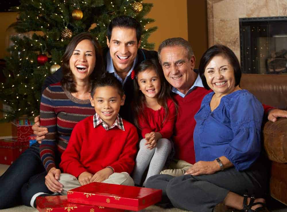 Multi-generational family in front of a Christmas tree