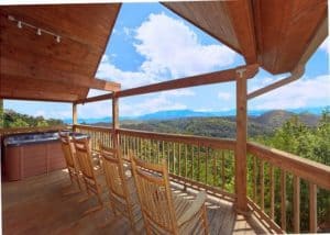 Rocking chairs on a porch at a Gatlinburg cabin with mountain views.
