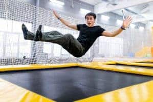 A young man at a trampoline park.