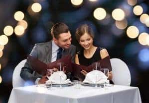 Happy couple enjoying a romantic dinner together at a restaurant.