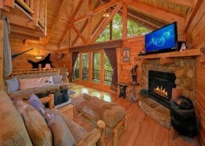 The cozy living room of a Gatlinburg TN cabin with a fireplace.