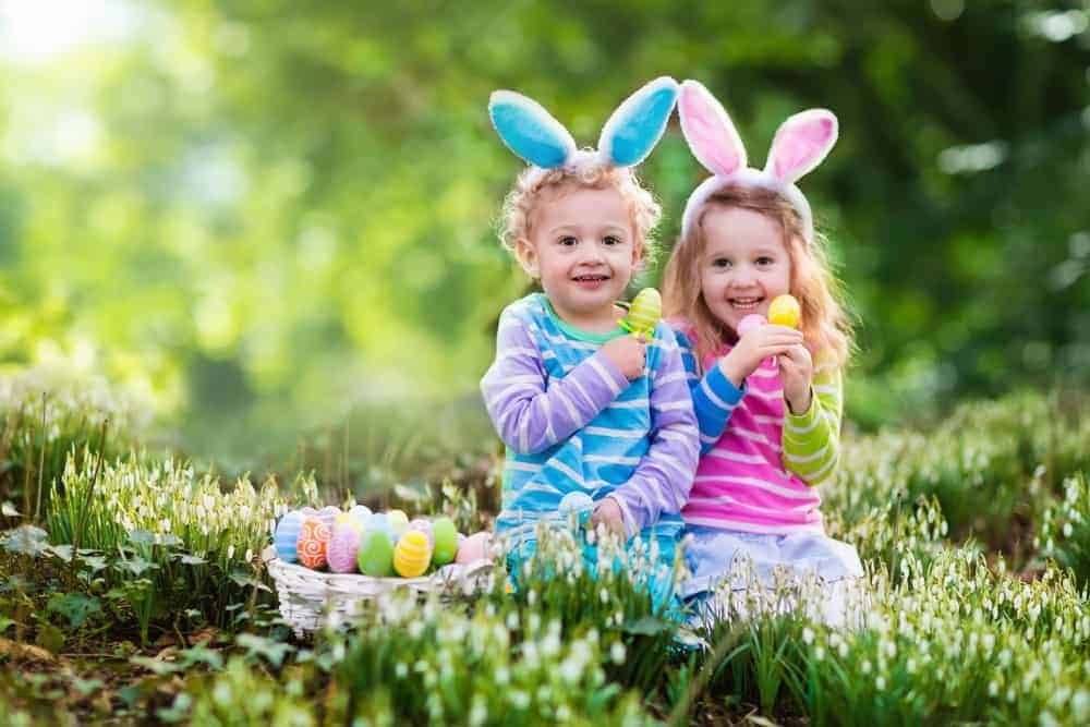 Young kids with bunny ears and Easter eggs.